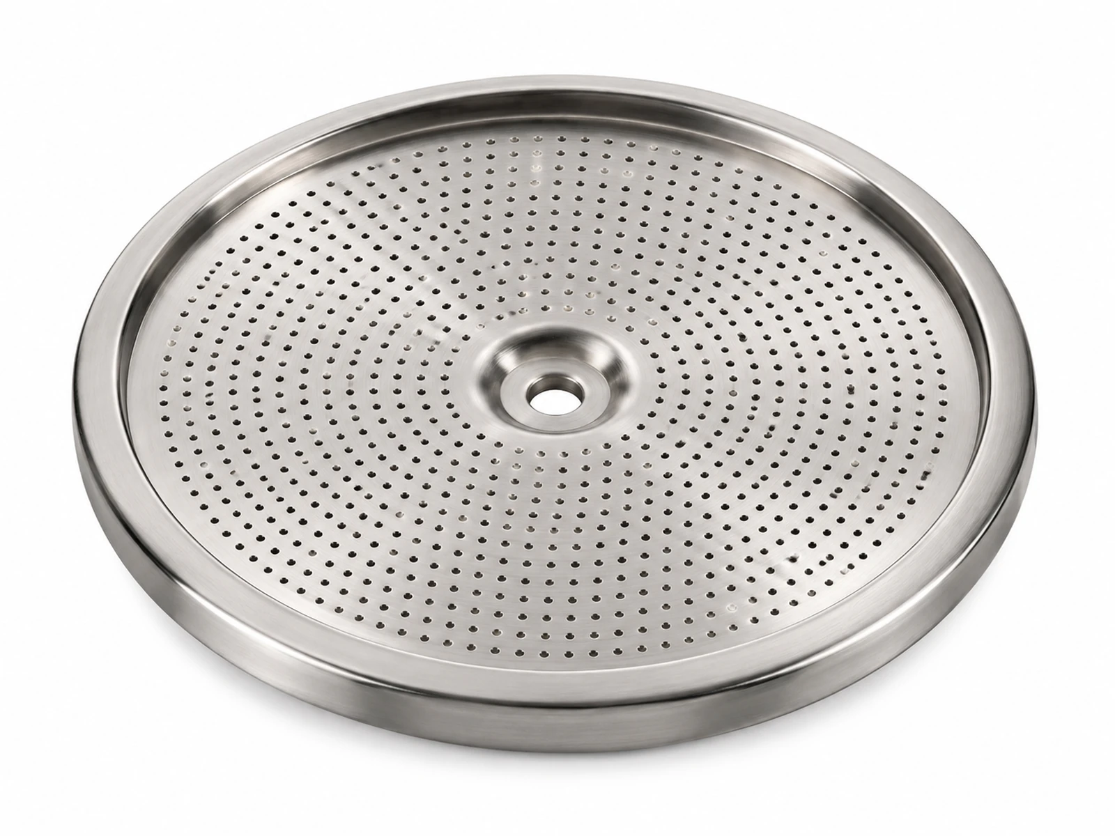 A round perforated stainless steel espresso group head shower screen removed from a chrome espresso machine