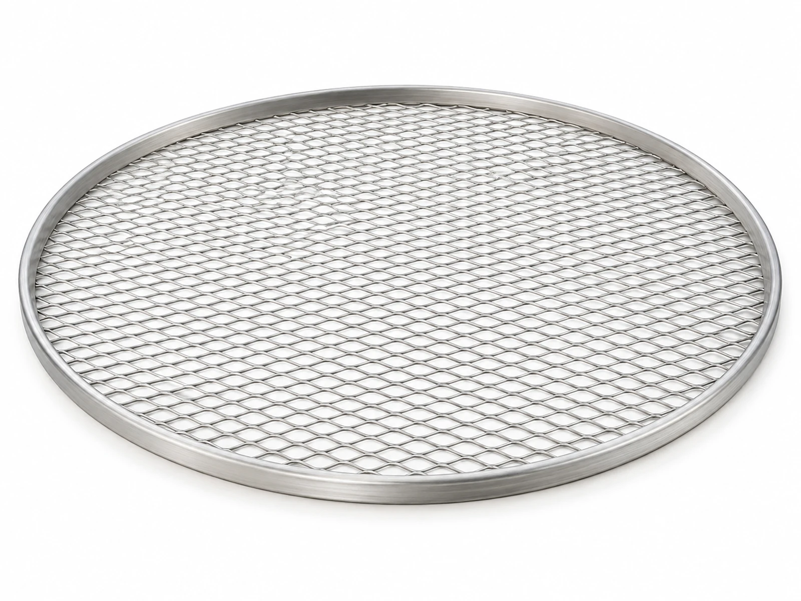 A round seamless expanded aluminum pizza screen with a baked pizza on top coming out of a conveyor oven in a pizzeria