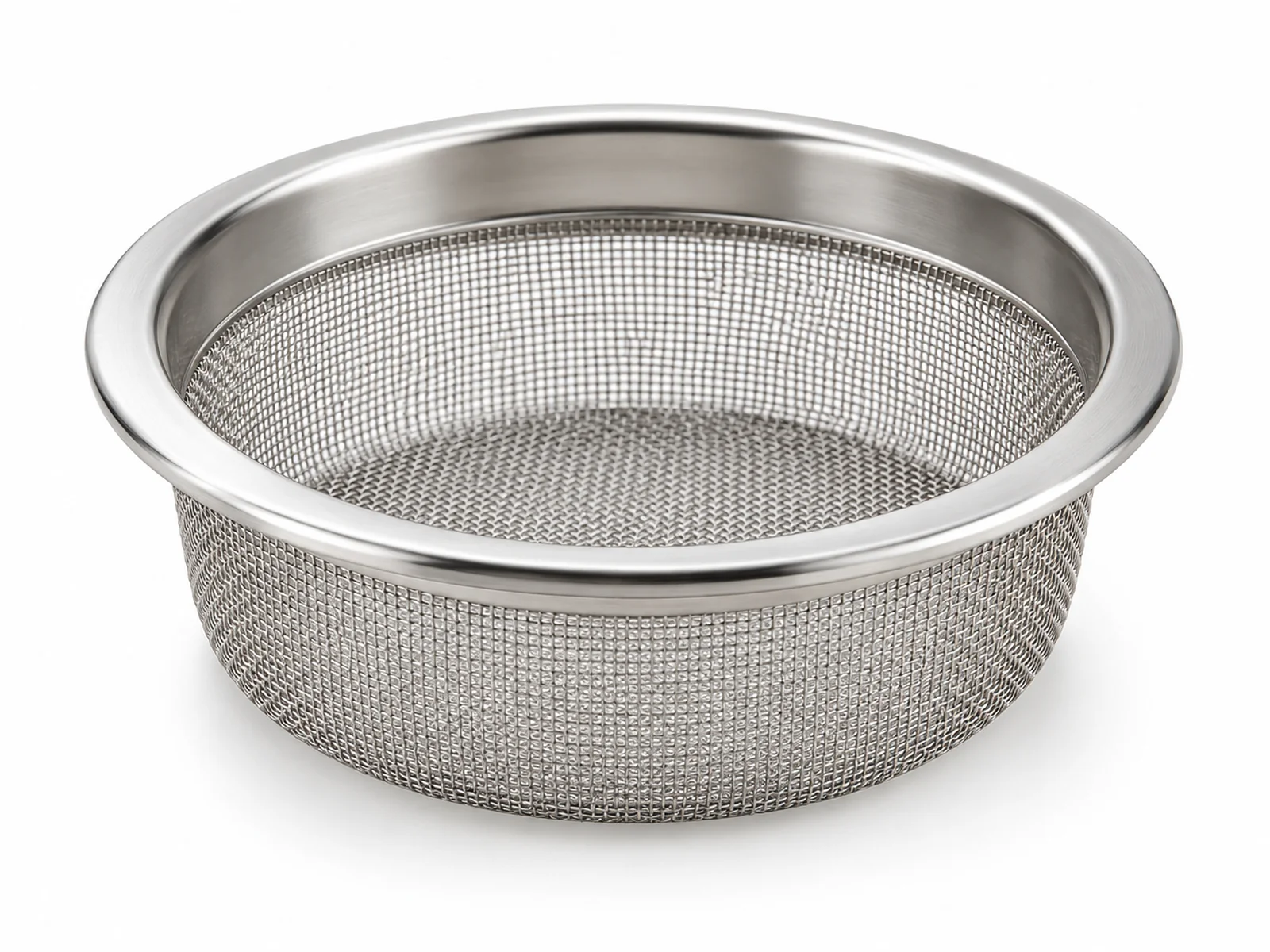 A small round stainless steel tissue sieve with fine mesh resting on a petri dish, syringe plunger and pipette beside it