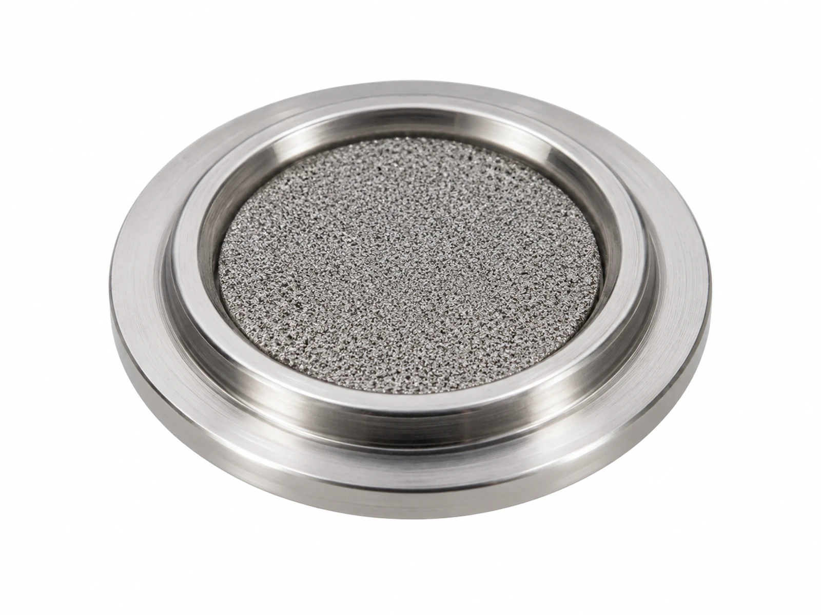 A tiny stainless steel face-seal gasket filter with a grey sintered center disc held in tweezers in a cleanroom